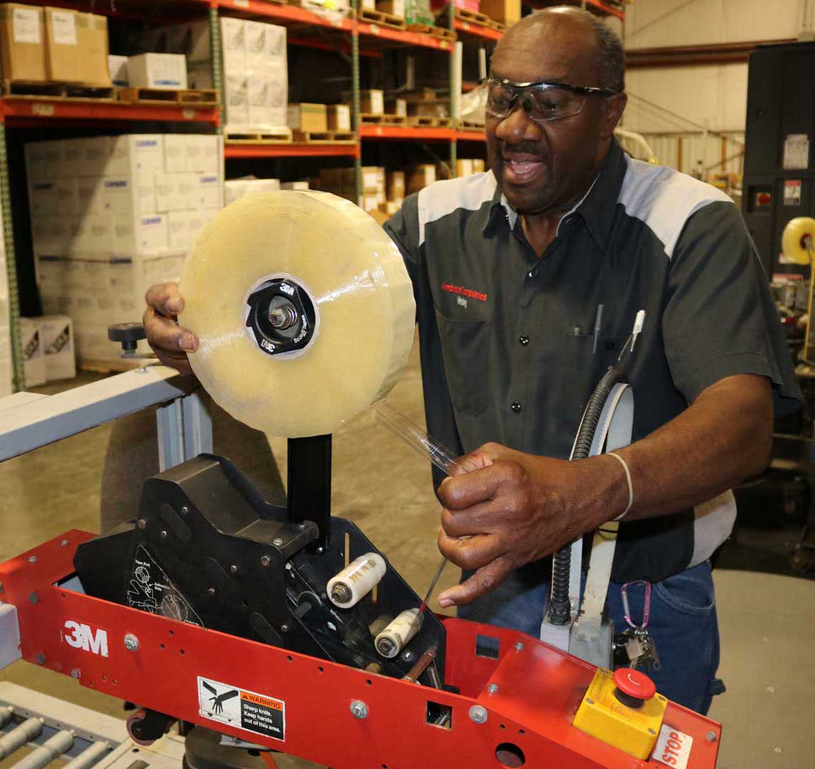 employee using sealer equipment