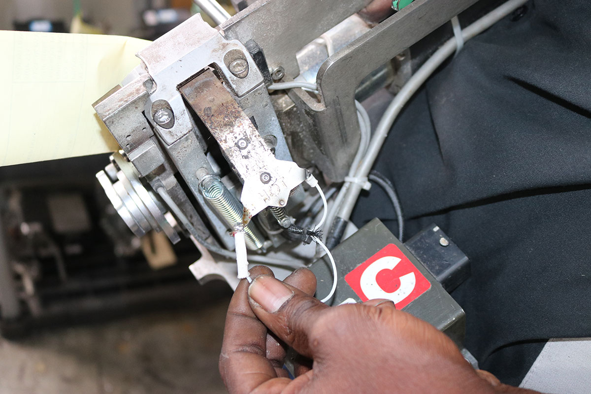 Man performing maintenance on packaging equipment